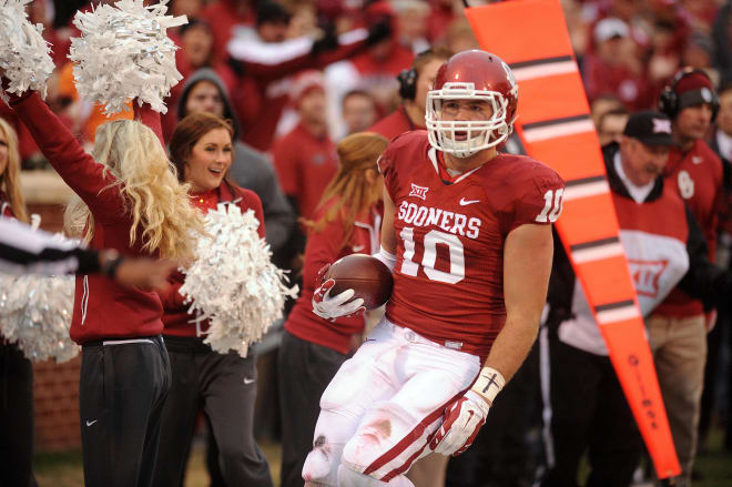 Dec 6, 2014; Norman, OK, USA; Oklahoma Sooners tight end Blake Bell (10) runs for a first down after a catch against the Oklahoma State Cowboys during the second quarter at Gaylord Family - Oklahoma Memorial Stadium. Mandatory Credit: Mark D. Smith-USA TODAY Sports