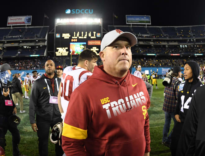 USC coach Clay Helton walks off the field after USC's 49-24 loss to Iowa in the Holiday Bowl at SDCCU Stadium on Friday night.