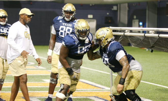 David Turner works with D'Quan Douse and Daniel Carson on Friday