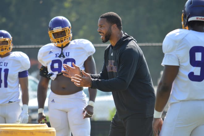 Pirate defensive linemen listen intently as former Texas All-American and new ECU defensive line coach Rod Wright teaches technique.
