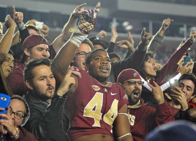 Demarcus Walker celebrates with fellow students going 4-0 in his career vs. the Gators.