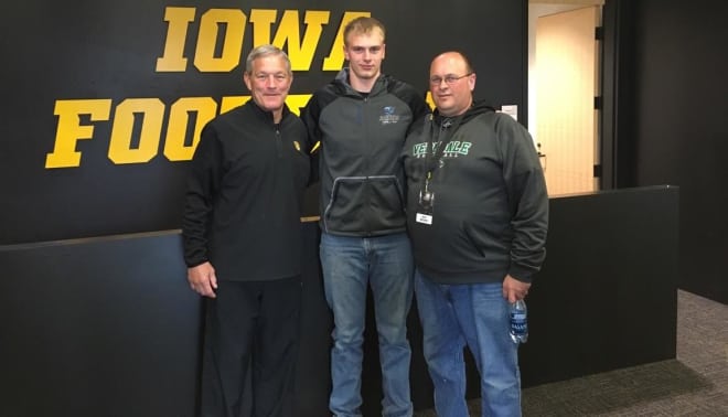Samuel Moore and his father, Jeff, with Iowa head coach Kirk Ferentz.