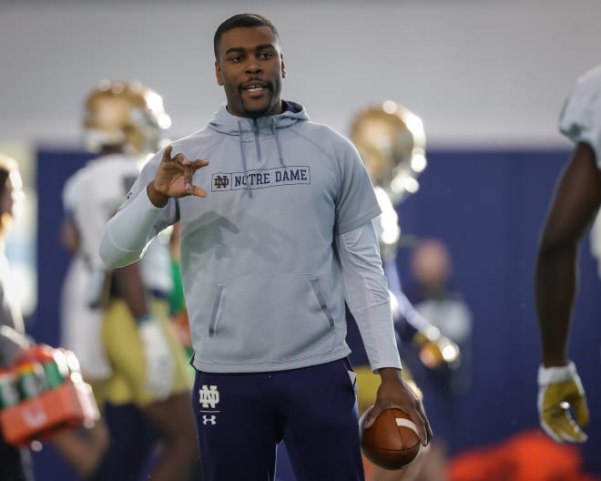 Notre Dame cornerbacks coach Mike Mickens runs his position group through a drill at Tuesday's spring football practice.