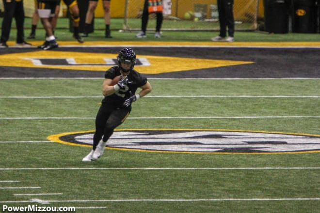 Micah Wilson turns upfield after securing a catch during Tuesday's practice.