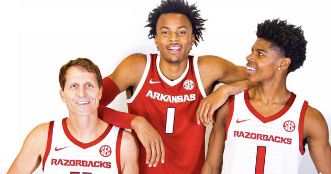 Top 150 ballers Moses Moody and KK Robinson pose with Arkansas head coach Eric Musselman.