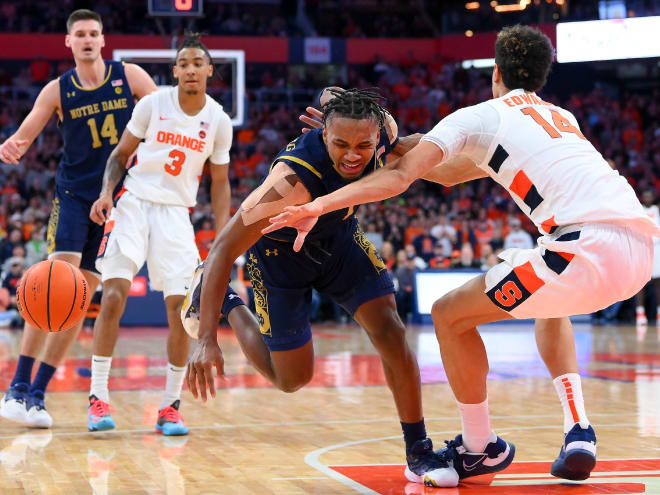 Notre Dame guard JJ Starling, middle, collides with Syracuse center Jesse Edwards in a 78-73 Irish loss at Syracuse.