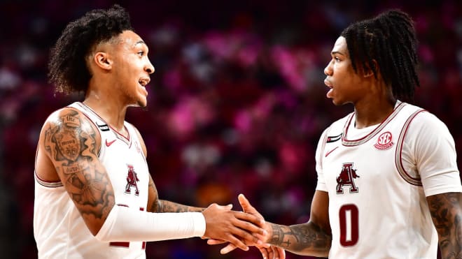 Arkansas guards Jeremiah Davenport (left) and Khalif Battle (right).