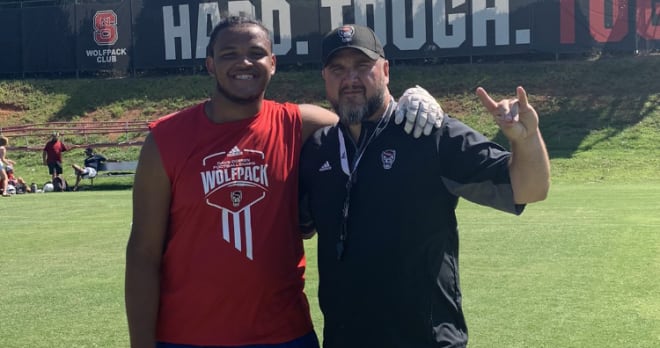 Mooresville (N.C.) Lake Norman High junior tackle Ethan Calloway, left, is with NC State offensive line coach John Garrison. NC State offered Calloway on Saturday.