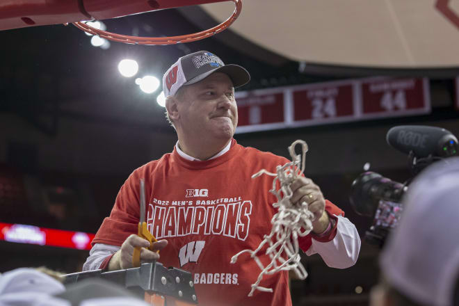 Wisconsin head coach Greg Gard cuts down the Kohl Center net following the Badgers' 70-67 win over Purdue.