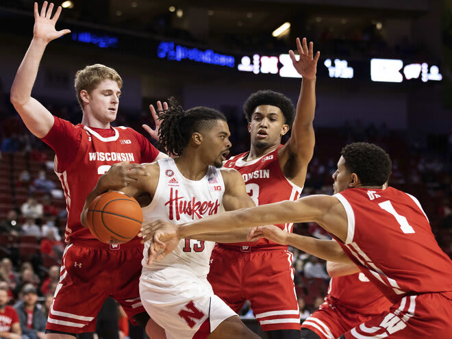 Nebraska's Derrick Walker (13) loses control of the ball against Wisconsin's Steven Crowl (22), Chucky Hepburn (23) and Jonathan Davis (1).