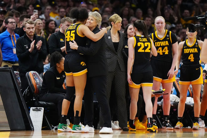 Apr 7, 2024; Cleveland, OH, USA; Iowa Hawkeyes forward Hannah Stuelke (45) embraces head coach Lisa Bluder in the fourth quarter against the South Carolina Gamecocks in the finals of the Final Four of the womens 2024 NCAA Tournament at Rocket Mortgage FieldHouse.