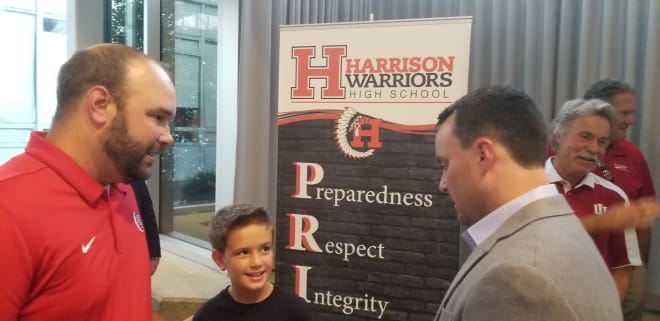 Miller (right) took the time to meet with several of the attendees, including Harrison High School head coach Nathan Fleenor and his son J.T. 