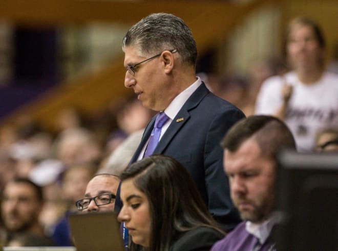 Colonial Athletic Association commissioner Joe D'Antonio looks at stats during a WNIT game between James Madison and Virginia Tech this past March at the Convocation Center in Harrisonburg.