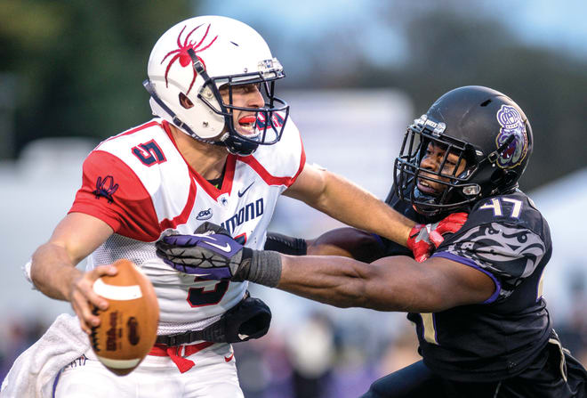 James Madison defensive end Darrious Carter (right) tackles Richmond quarterback Kyle Lauletta during the Dukes' win over the Spiders last season in Harrisonburg.