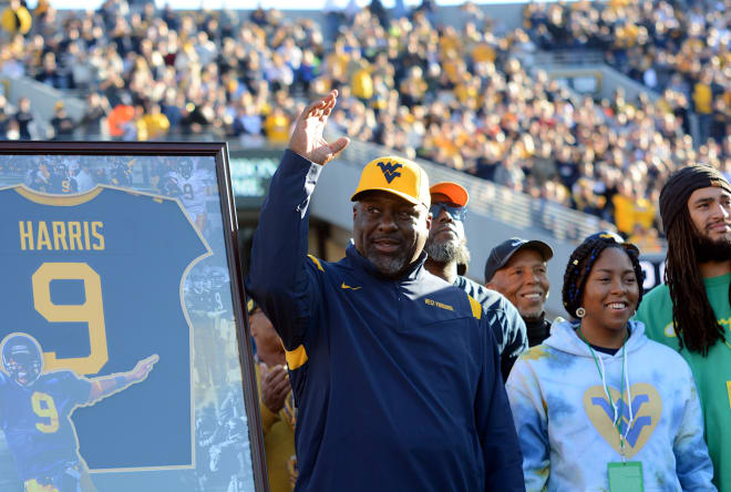 Major Harris waves to the crowd during his jersey retirement ceremony on Saturday.