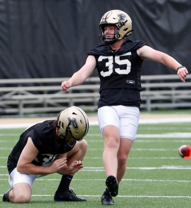 Purdue Boilermakers punter Keelan Crimmins (30) holds a field goal attempt for Purdue Boilermakers place kicker Spencer Porath (35) Thursday, Aug. 1, 2024, during Purdue football practice at Bimel Outdoor Practice Complex in West Lafayette, Ind. © Alex Martin/Journal and Courier / USA TODAY NETWORK