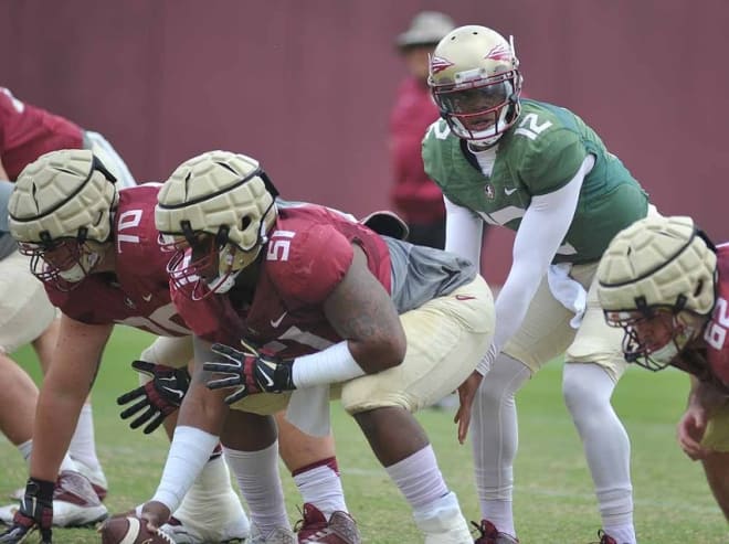 Redshirt freshman center Baveon Johnson, center, has worked heavily with redshirt sophomore quarterback Deondre Francois during Florida State's spring camp.