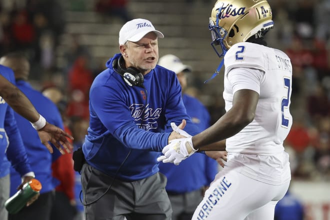 Philip Montgomery talks to WR Keylon Stokes during Saturday's game at Houston.