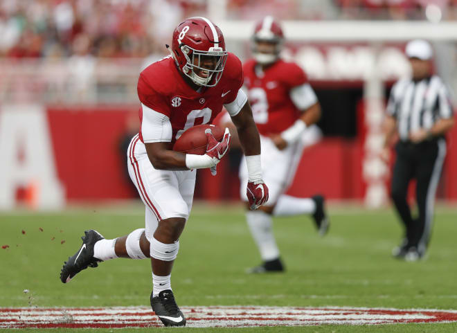 Alabama running back Josh Jacobs poses with his new team jersey