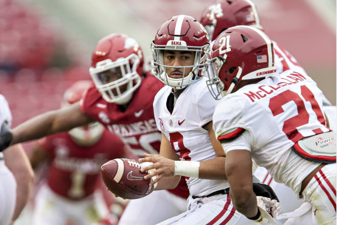 Alabama Crimson Tide quarterback Bryce Young hands the ball off to running back Jase McClellan. Photo | Getty Images