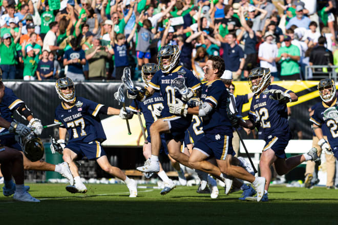 Brian Tevlin (no helmet) celebrates his game-winning goal with his Notre Dame teammates on Saturday in Philadelphia.