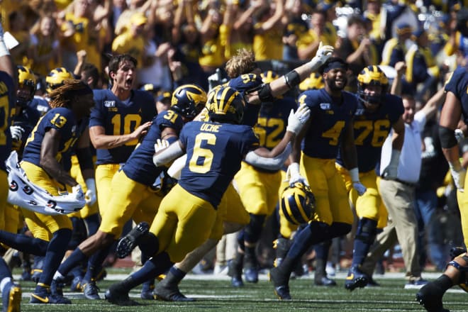 Michigan players celebrate wildly after holding on to beat Army in double overtime at home.