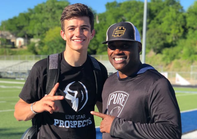 Austin "Kade" Renfro, pictured here with QB coach P.J. Wilson, has caught the attention of UCF's staff.