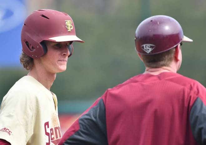 Freshman Tyler Martin talks to his dad, FSU head coach Mike Martin Jr., during a game in 2020's COVID-shortened season.