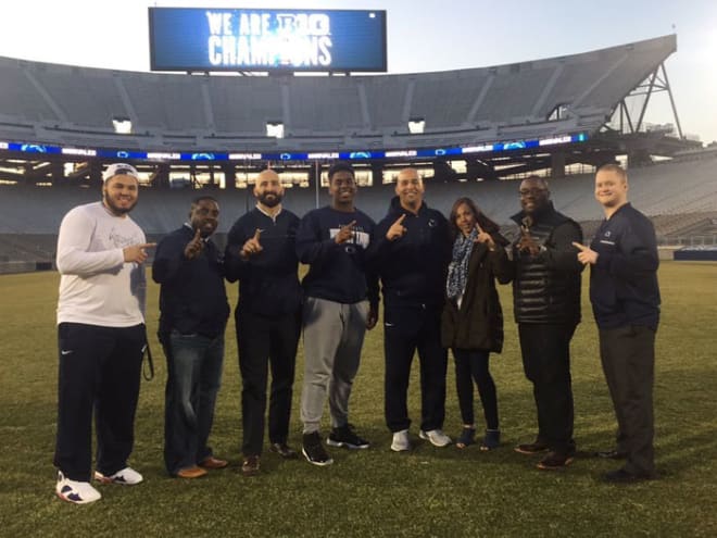 Hawkins and his mother pose with the PSU staff during a visit in March.