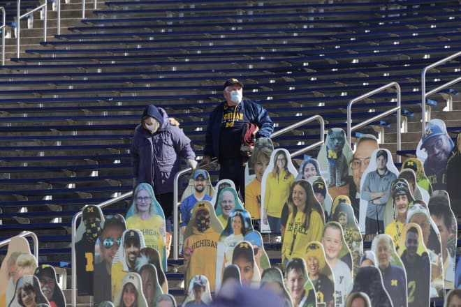 The cardboard cutouts far outnumbered actual fans in the stands during Michigan's first home game.