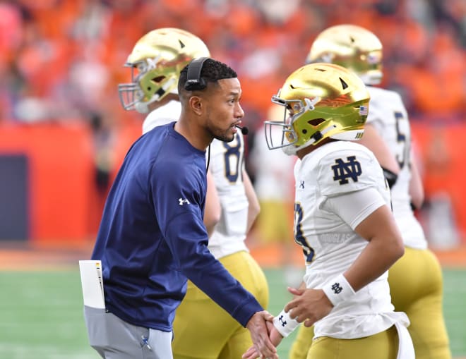 Head coach Marcus Freeman congratulates his team after scoring a touchdown against Syracuse.  