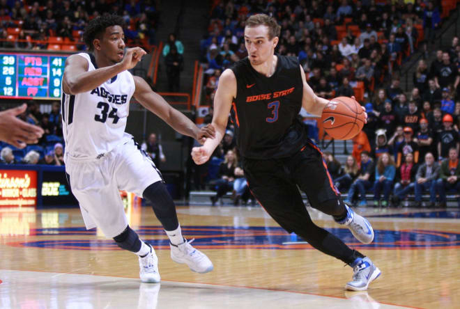 Boise State Broncos guard Anthony Drmic (3) handles the ball against Utah State Aggies guard Chris Smith (34) during second half action at Taco Bell Arena. Boise State defeats Utah State 70-67.