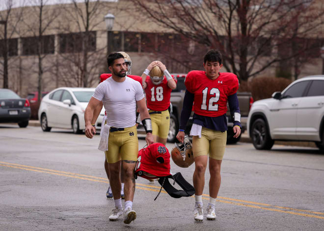 Incoming Notre Dame transfer QB Sam Hartman (left) and outgoing transfer QB Tyler Buchner (12) became friends and helped each other during their relatively brief roster overlap.