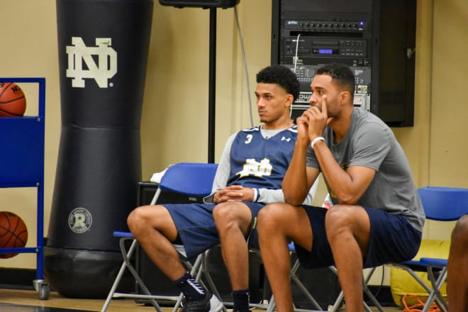 Point guard Prentiss Hubb (left) watches Sunday's practice with assistant coach Ryan Ayers.
