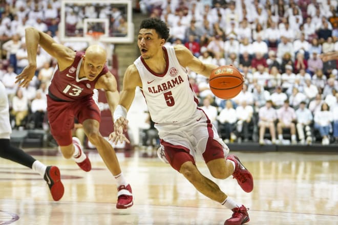 Alabama Crimson Tide guard Jahvon Quinerly (5) drives to the basket against Arkansas Razorbacks guard Jordan Walsh (13) during the second half at Coleman Coliseum. Photo | Marvin Gentry-USA TODAY Sports
