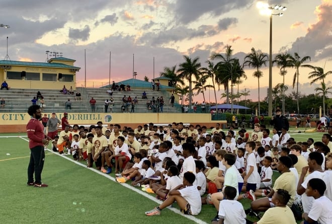 Former FSU defensive back Marlin Green speaks with the young football players Friday in Lauderhill.