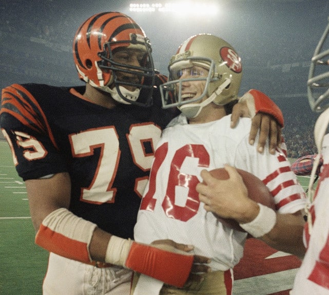 Cincinnati's Ross Browner congratulates San Francisco's Joe Montana, teammates on Notre Dame's 1977 national champs, after the 1982 Super Bowl.