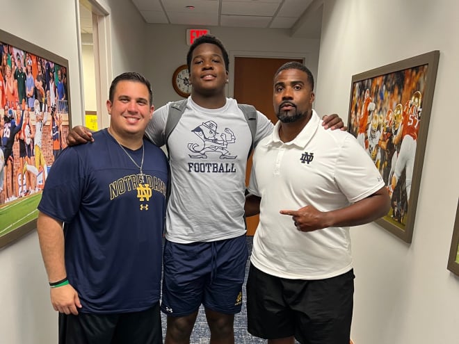 Four-star defensive lineman Elijah Golden, a 2026 recruit, poses with defensive analyst Nick Sebastian, left, and defensive line coach Al Washington, right.