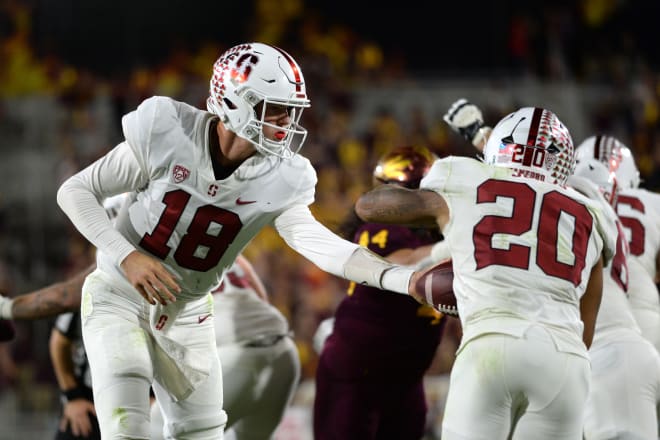 Stanford quarterback Tanner McKee hands the ball off to running back Austin Jones. 