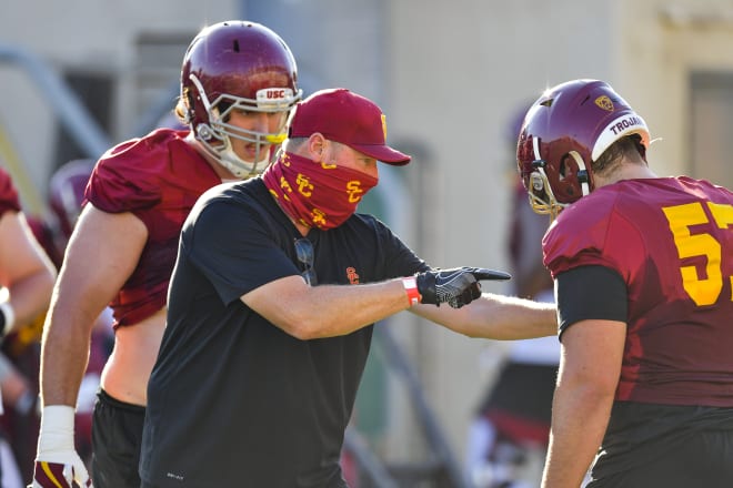 USC offensive line coach Tim Drevno instructs redshirt sophomore Justin Dedich at practice Monday.