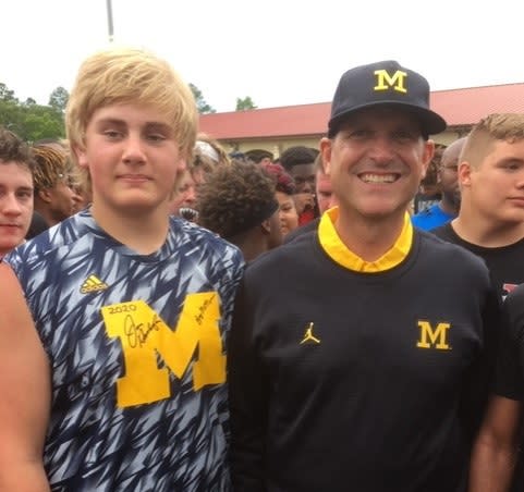 A young Austin Blaske poses with Jim Harbaugh in Valdosta