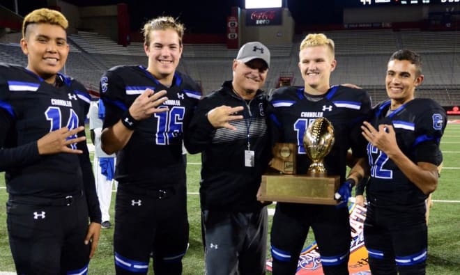 Rick Garretson poses with Chandler's group of quarterbacks after the 2017 State Championship