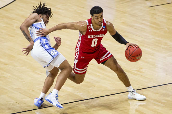 Wisconsin's D'Mitrik Trice (0) moves by North Carolina's RJ Davis during the second half of the Badgers' 23-point win over the Tar Heels.