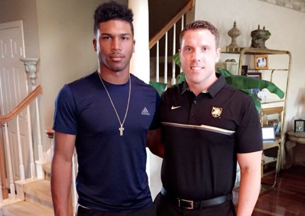 Harris here with Army fullback coach Mike Viti during recent home visit