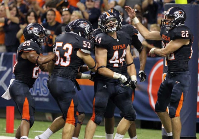 Steven Kurfehs celebrates with teammates after scoring the first ever pick-six in program history against Bacone.