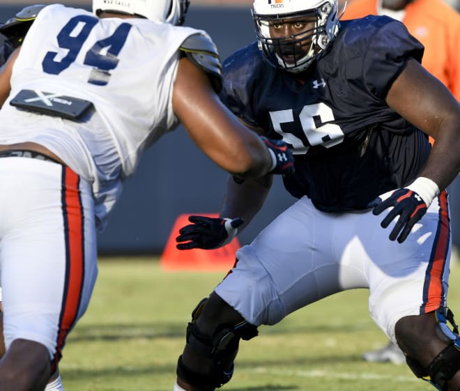 Offensive guard Tashawn Manning (56) prepares to block defensive tackle Tyrone Truesdell (94).