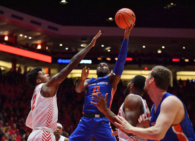 ALBUQUERQUE, NEW MEXICO - DECEMBER 04: Marcus Dickinson #0 of the Boise State Broncos shoots against Vance Jackson #2 of the New Mexico Lobos during their game at Dreamstyle Arena - The Pit on December 04, 2019 in Albuquerque, New Mexico.