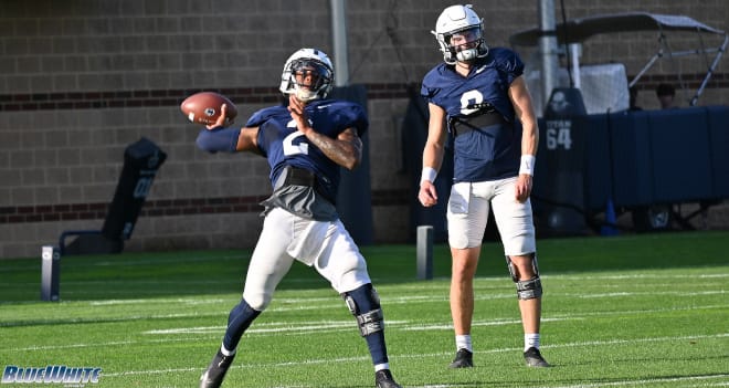 Ta'Quan Roberson throws a pass as Christian Veilleux looks on during a Penn State Nittany Lions practice in 2021. BWI photo