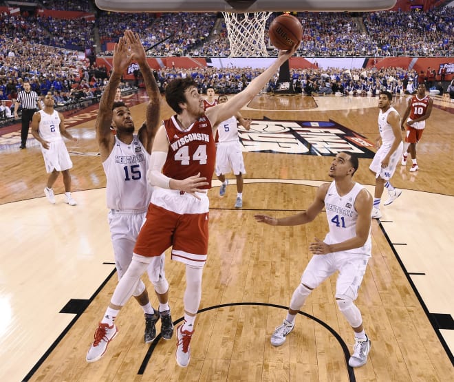 Wisconsin's Frank Kaminsky (44) drives to the basket between Kentucky's Willie Cauley-Stein (15) and Trey Lyles (41) during the second half of the NCAA Final Four.