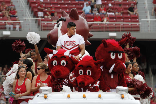 In this Sept. 5, 2015, photo, Arkansas spirt squads and mascots, from left, Sue E, Pork Chop and Big Red arrive at the field on the top of a truck before the start of the NCAA college football game against UTEP at Donald W. Reynolds Razorback Stadium in Fayetteville, Ark. The Razorbacks beat the Miners, 48-13.